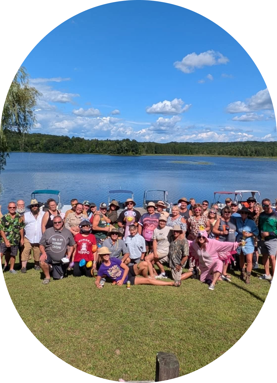 Large group enjoying a sunny day by the lake.